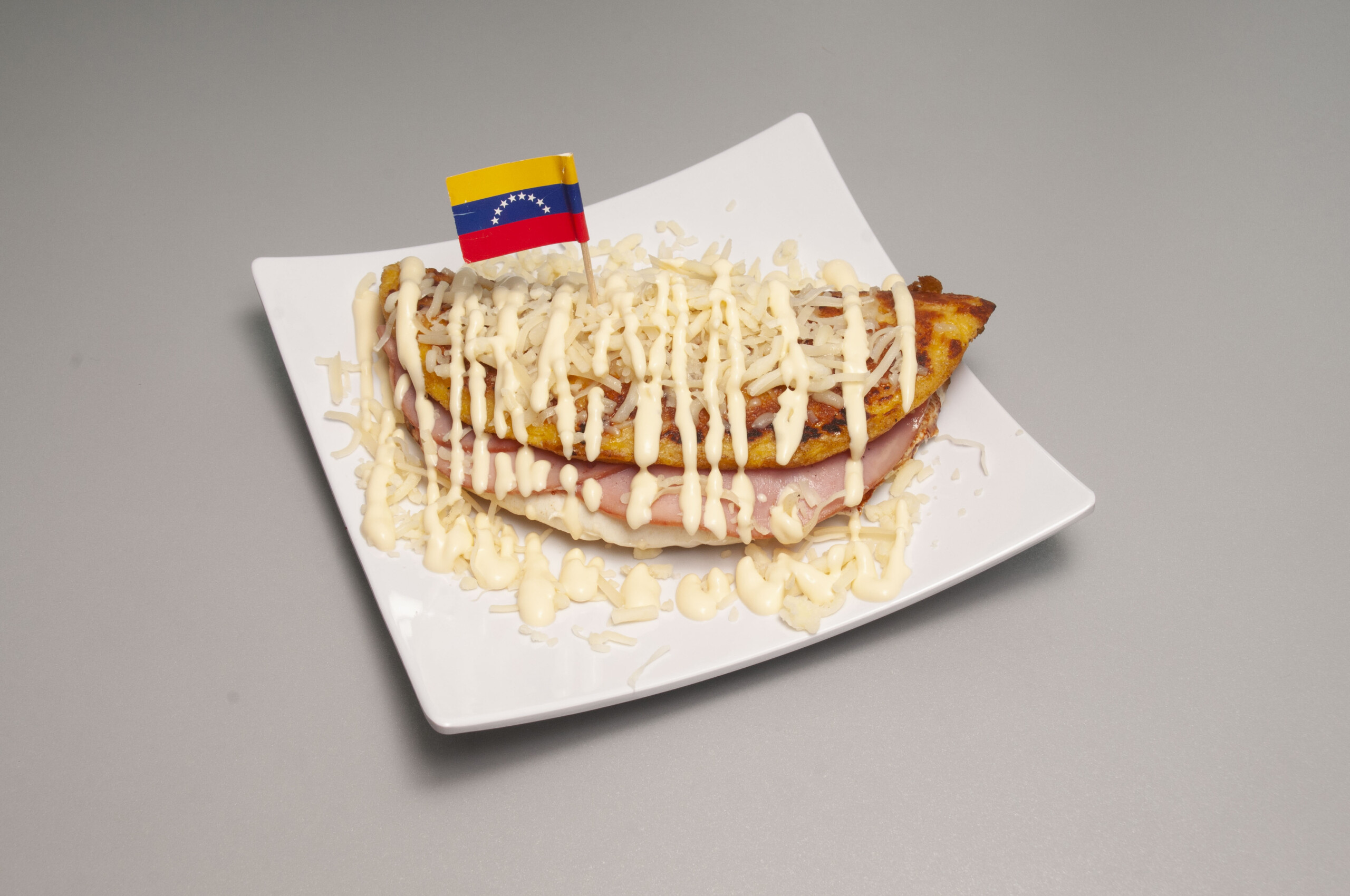 un plato con una cachapa venezolana servida con queso de mano