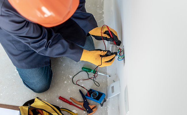 handyman reparando una conexion electrica en una casa